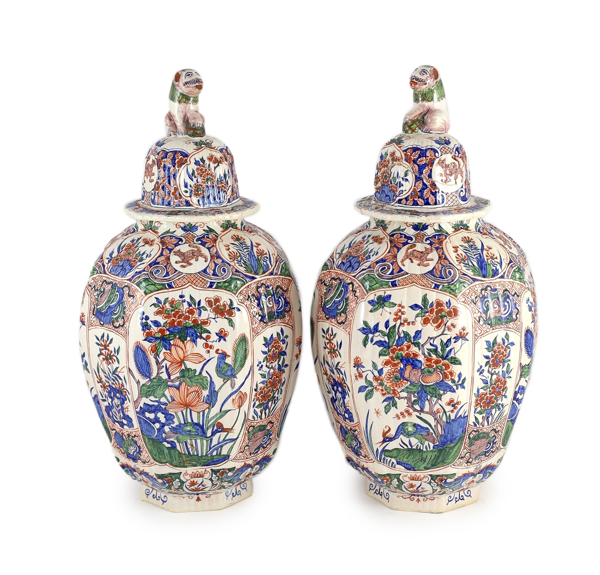 A pair of large Delft jars and covers, Pieter Kocx factory De Grieksche A, c.1701-1722, 50.5cm high, damage to covers